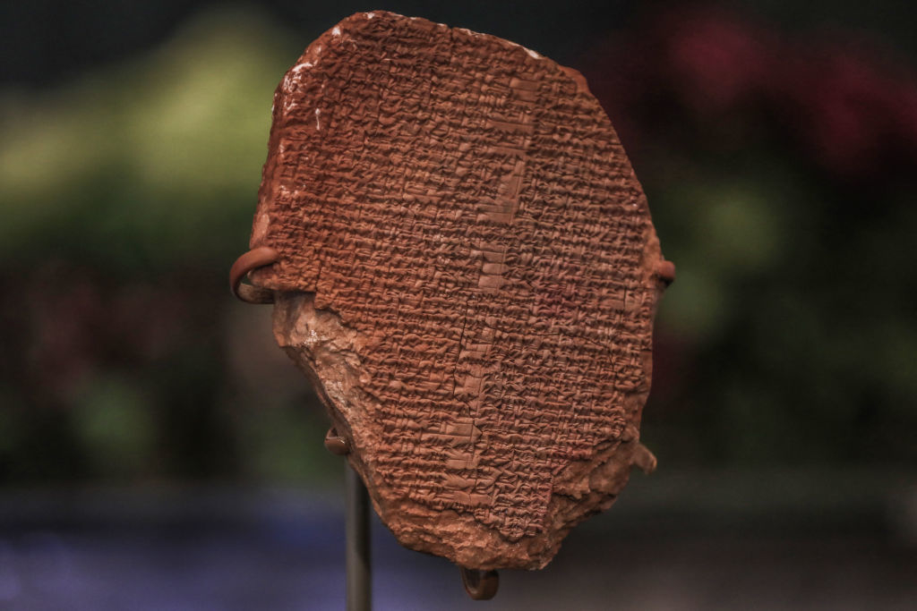 Ancient clay tablet with uniform cuneiform script on display