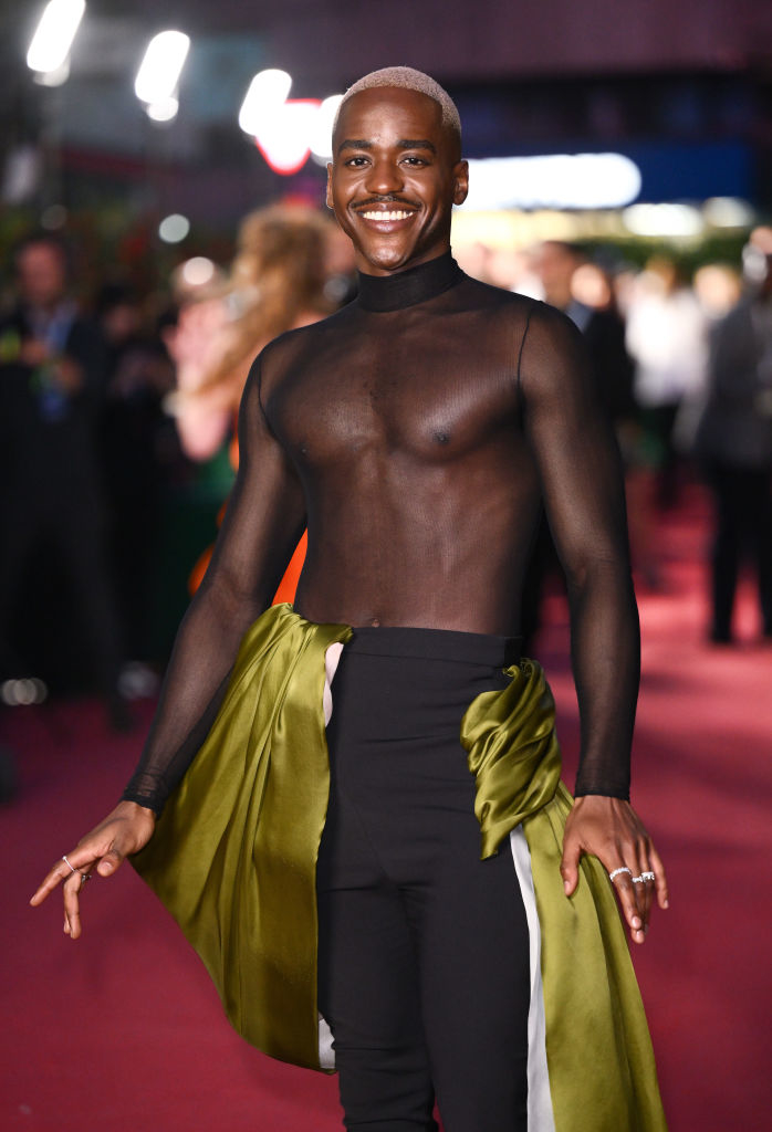 Ncuti in a sheer top with a draped detail at the waist on the red carpet