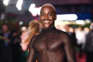 Ncuti posing on the red carpet in a sheer top
