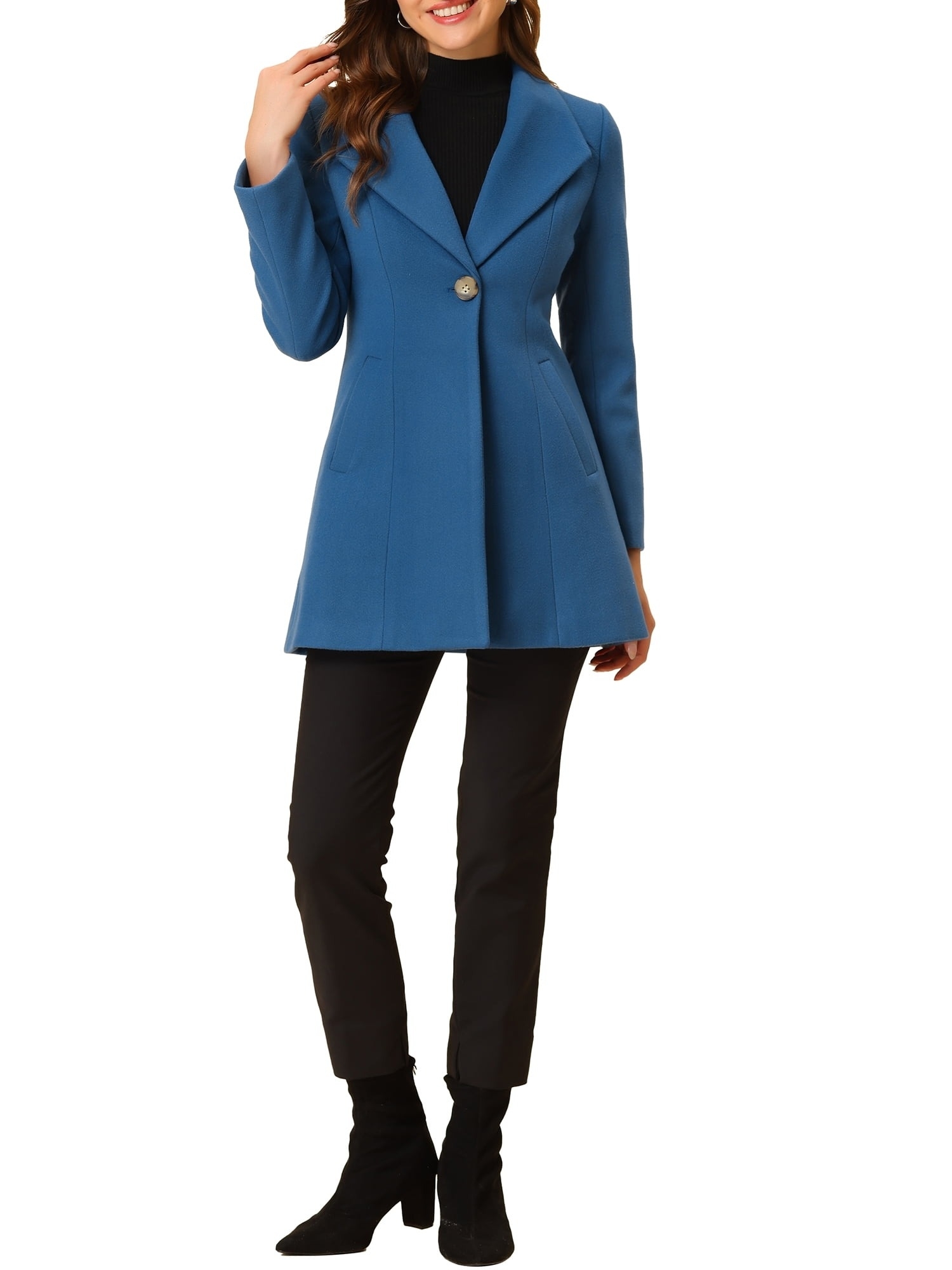 a model in a stylish blue peacoat with a large button, paired with black pants and heeled boots