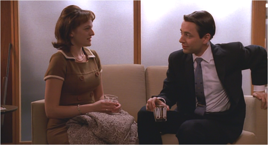 Peggy Olson and Pete Campbell sitting and talking in an office setting