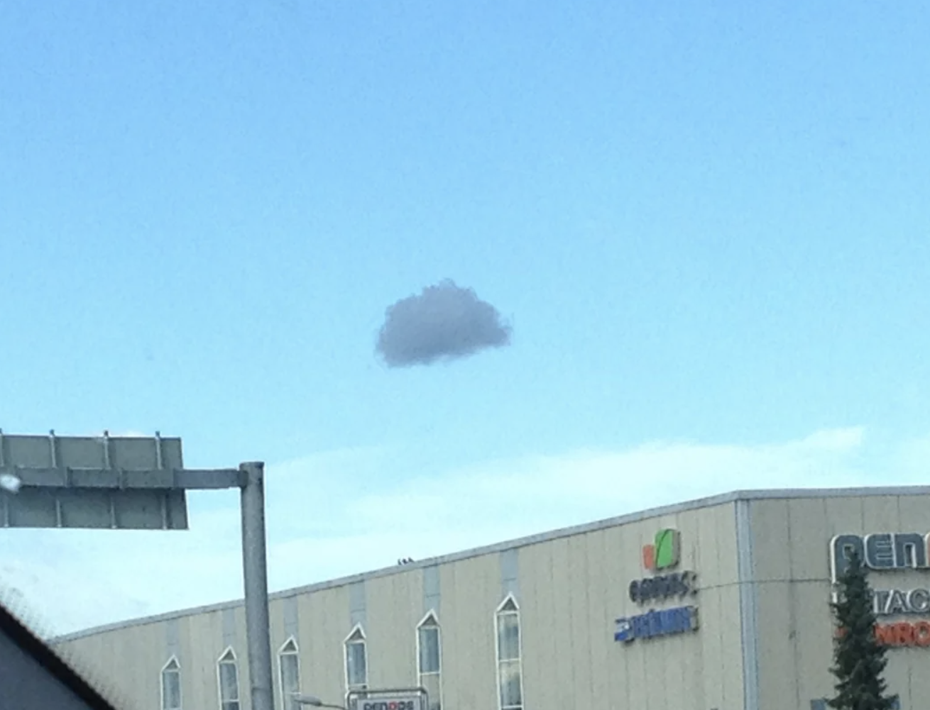 Small cloud in the sky above a building