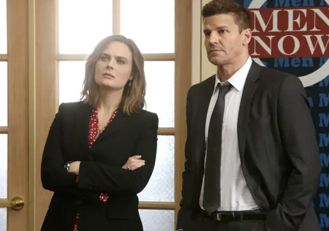 Temperance Brennan and Seeley Booth standing together and looking serious