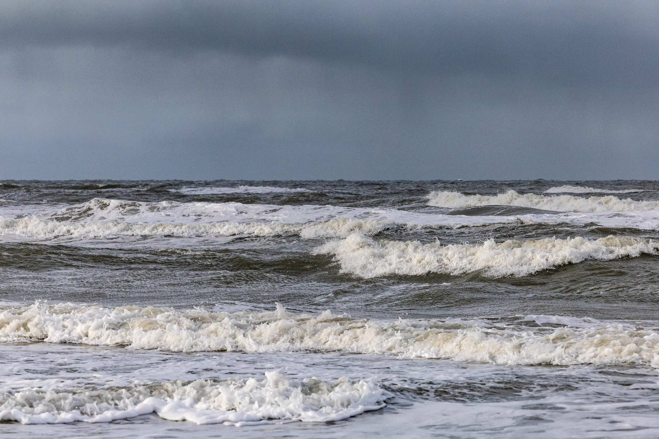Stormy sea with choppy waves under an overcast sky
