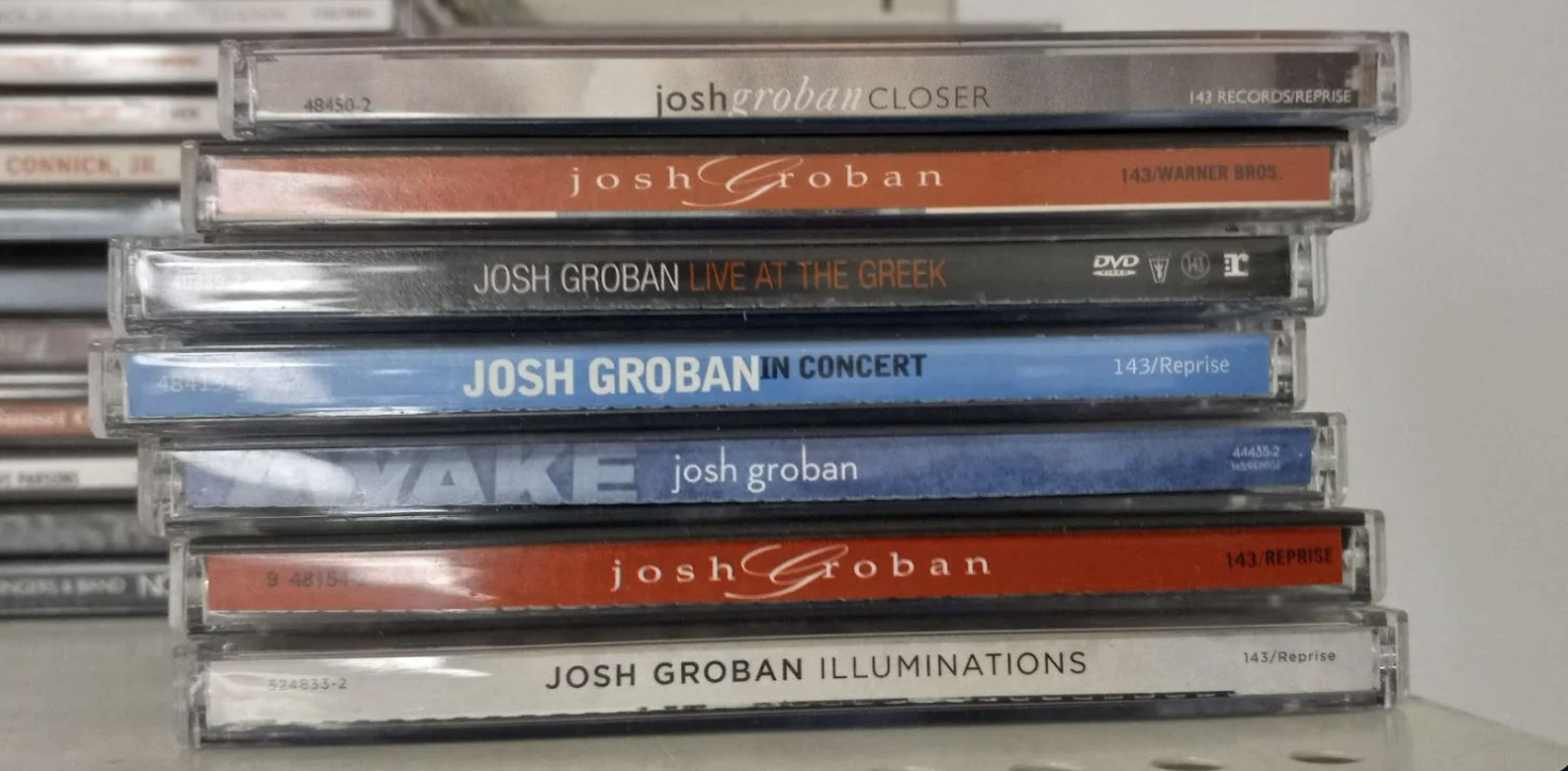 A stack of various Josh Groban CDs