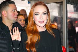 Lindsay Lohan wearing a long-sleeve black dress with a crystal-embellished waist cut-out