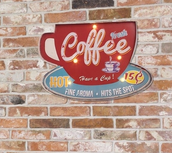 Vintage coffee shop sign with neon-style lights against a brick wall, ideal for home decor