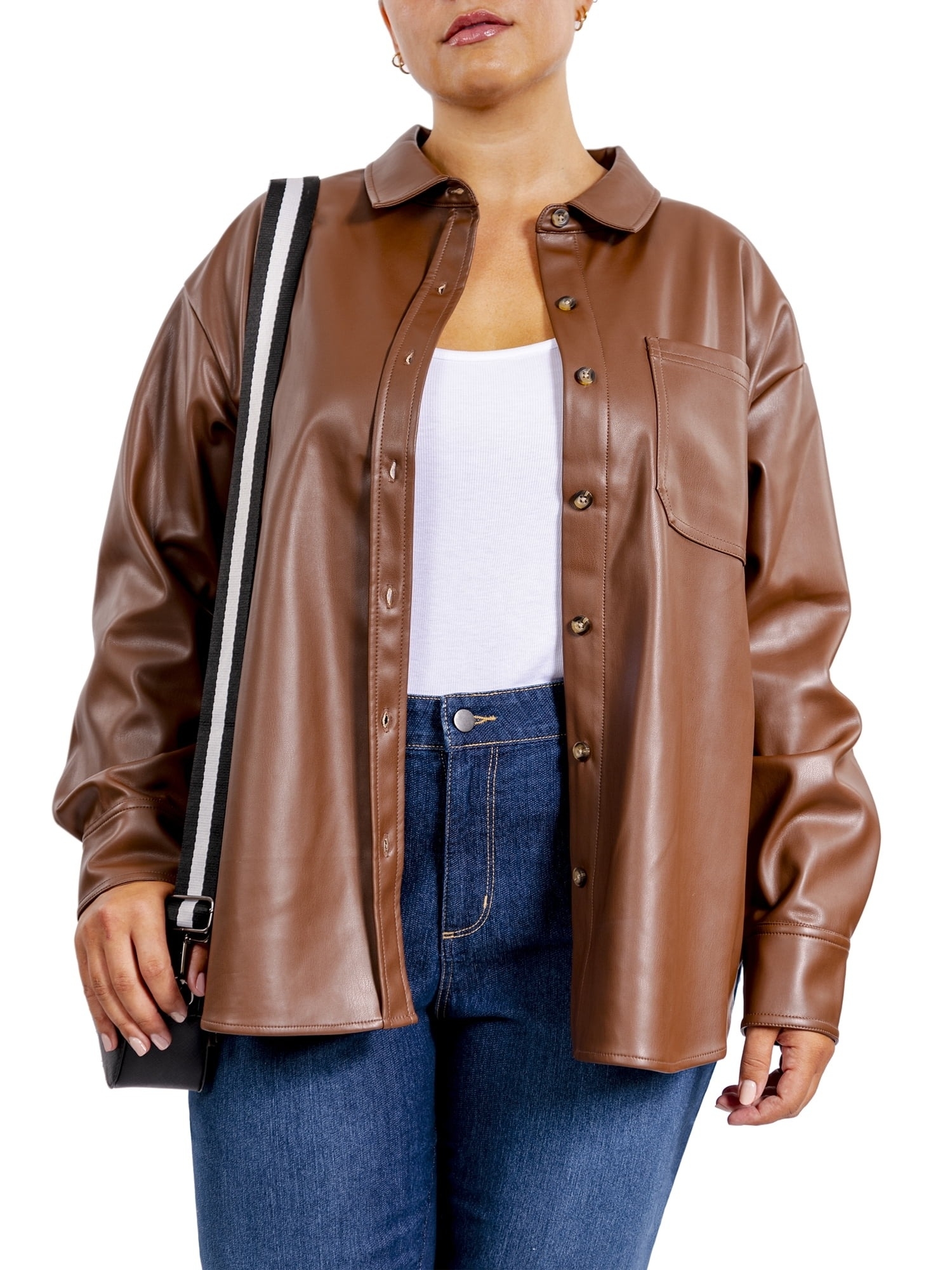 Model in a faux leather shirt jacket, white top, and jeans