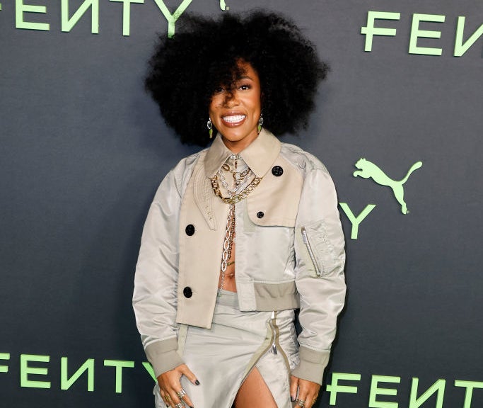 Jonica at Fenty event wearing a layered ensemble with a jacket, oversized necklace, and high-top sneakers