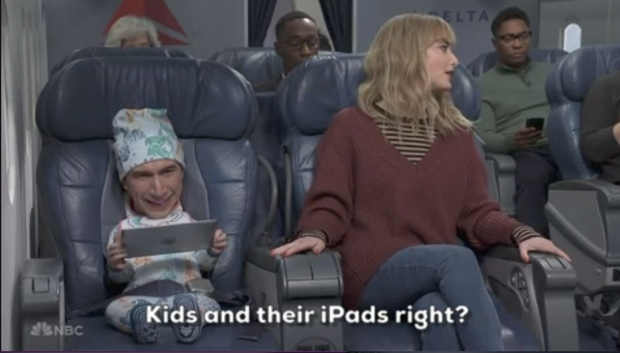 Two characters on an airplane; one, a baby with a human head, holding a tablet, both seated, with text "Kids and their iPads right?"