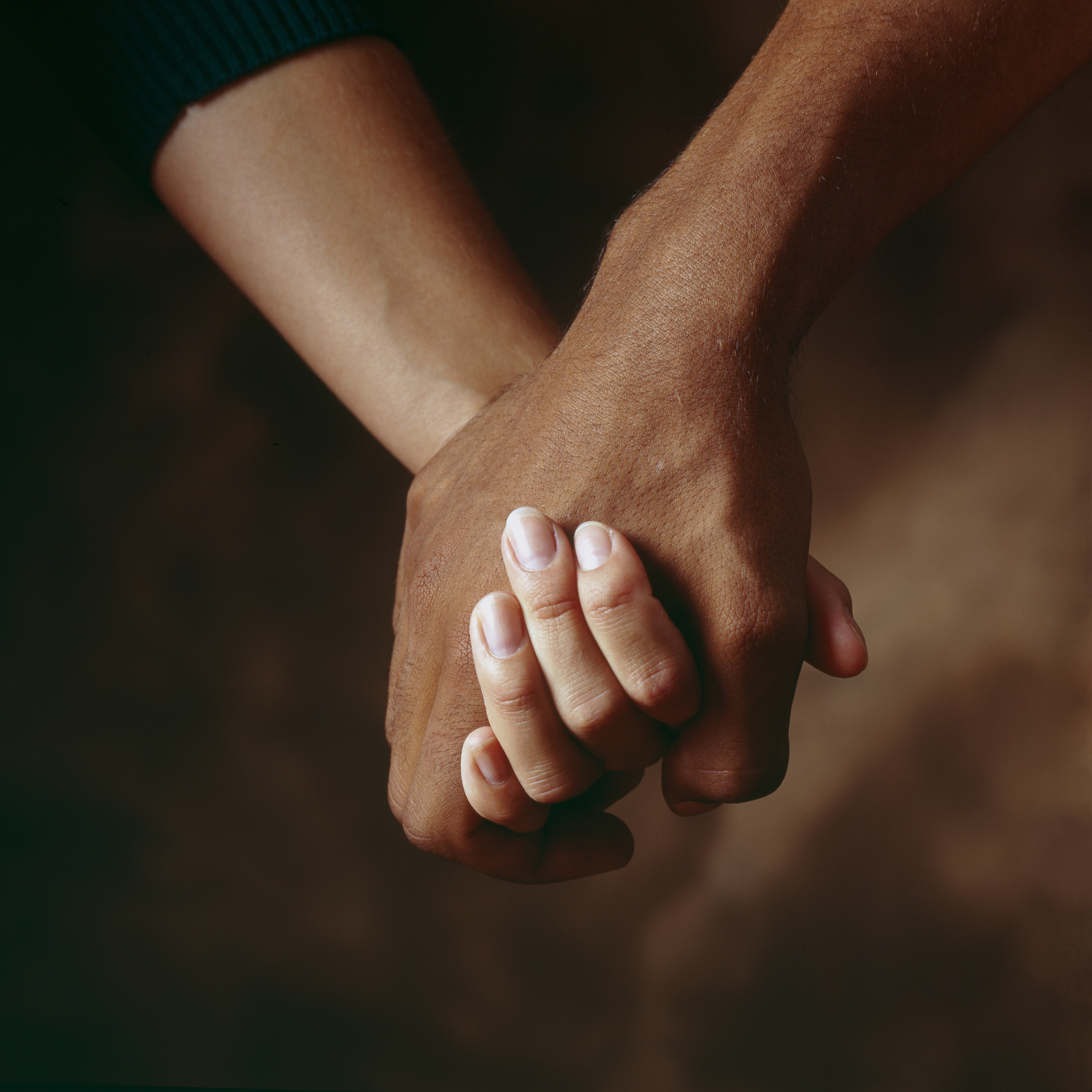Two hands clasped, symbolizing connection and intimacy