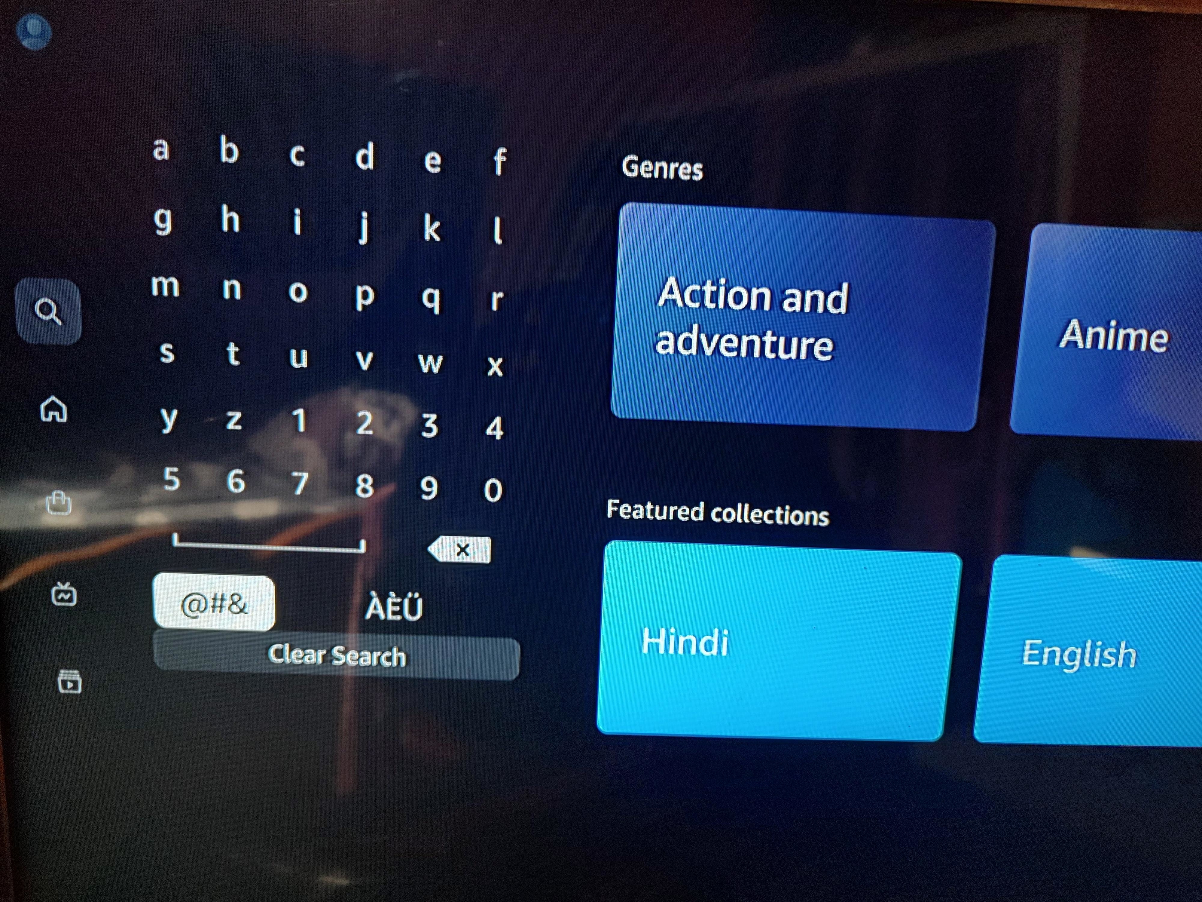 On-screen keyboard displayed with genre options for movies and TV shows on a streaming platform