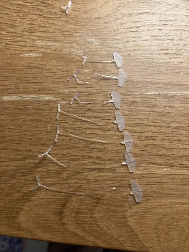 plastic tags from a pack of socks arranged in a line on a wooden surface
