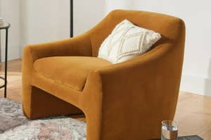 Plush armchair with a textured throw pillow in a living room setting