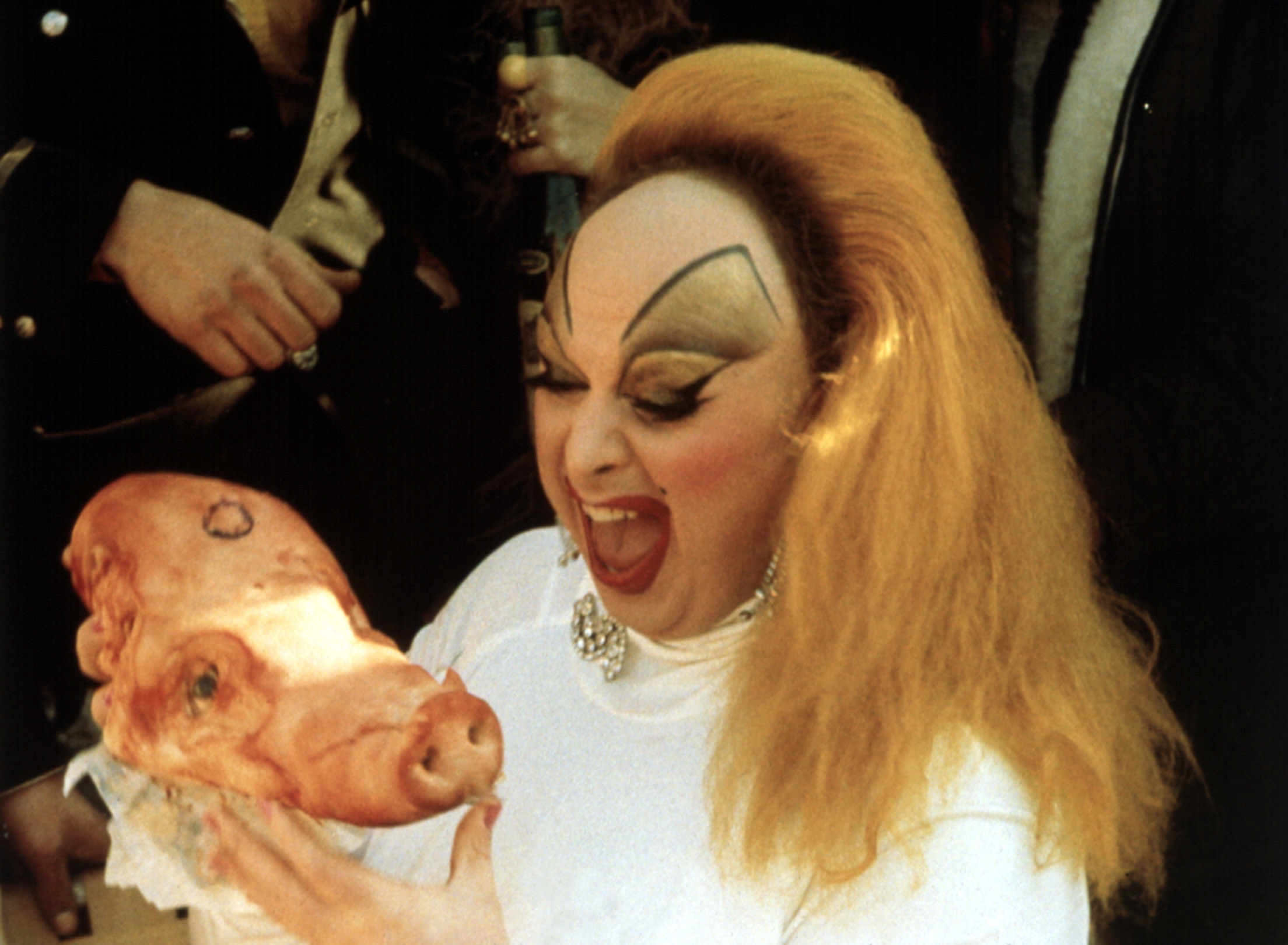 Drag queen Divine holds a pig head