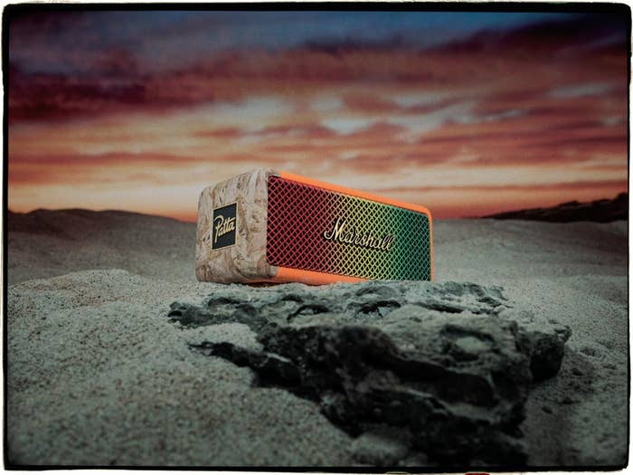Marshall portable speaker on sand with a sunset backdrop