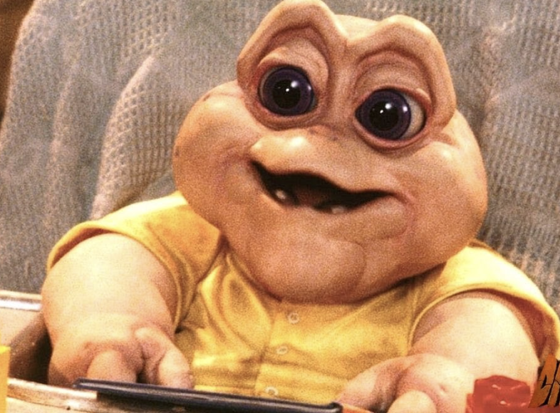 Baby Sinclair looking the same and sitting and smiling