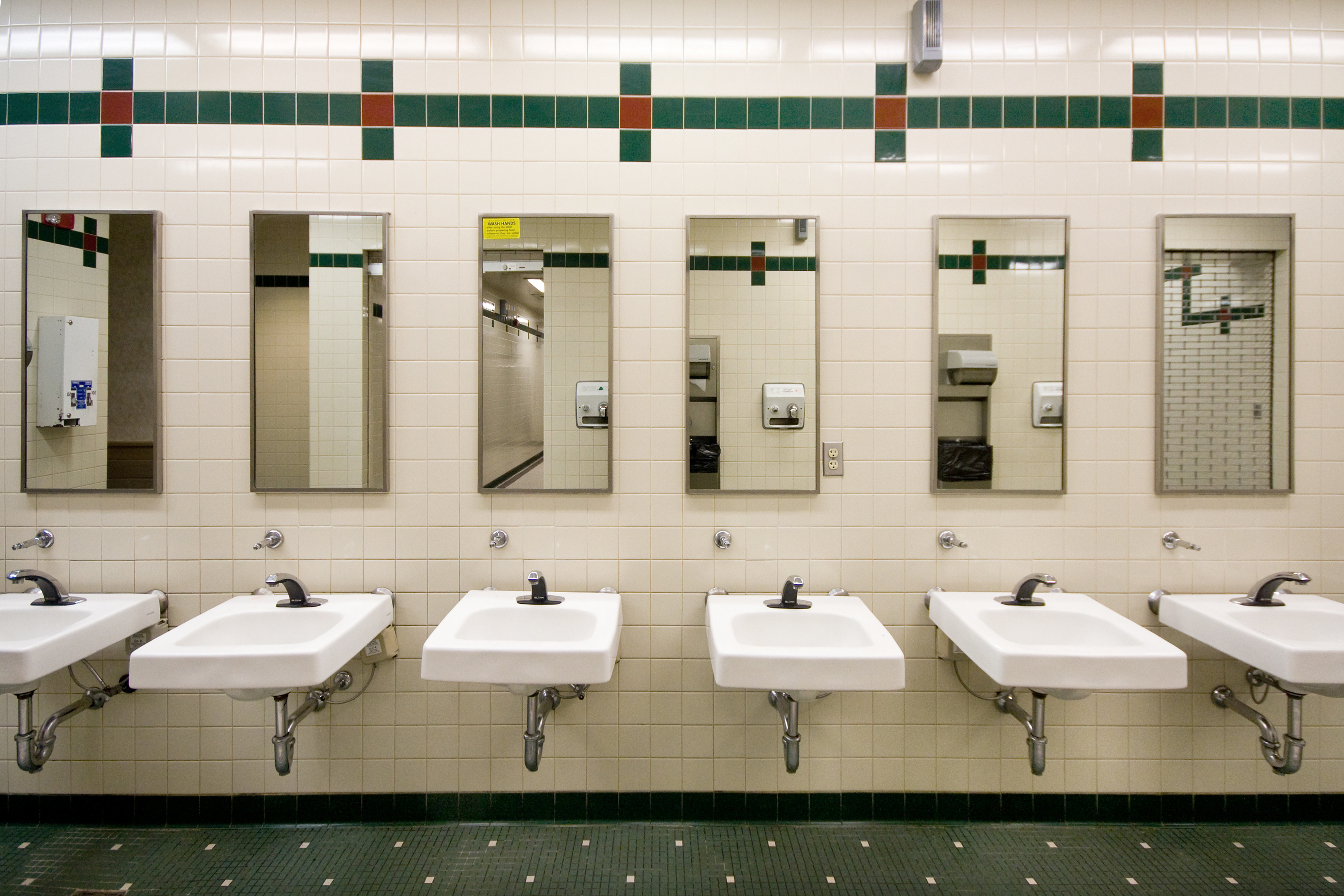 Public restroom with a line of sinks and mirrors