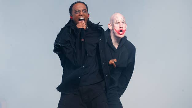 Playboi Carti on stage with a clown-painted dancer