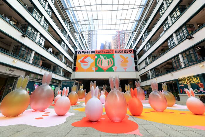 Public space with Easter decorations and oversized egg sculptures, high-rise buildings in backdrop