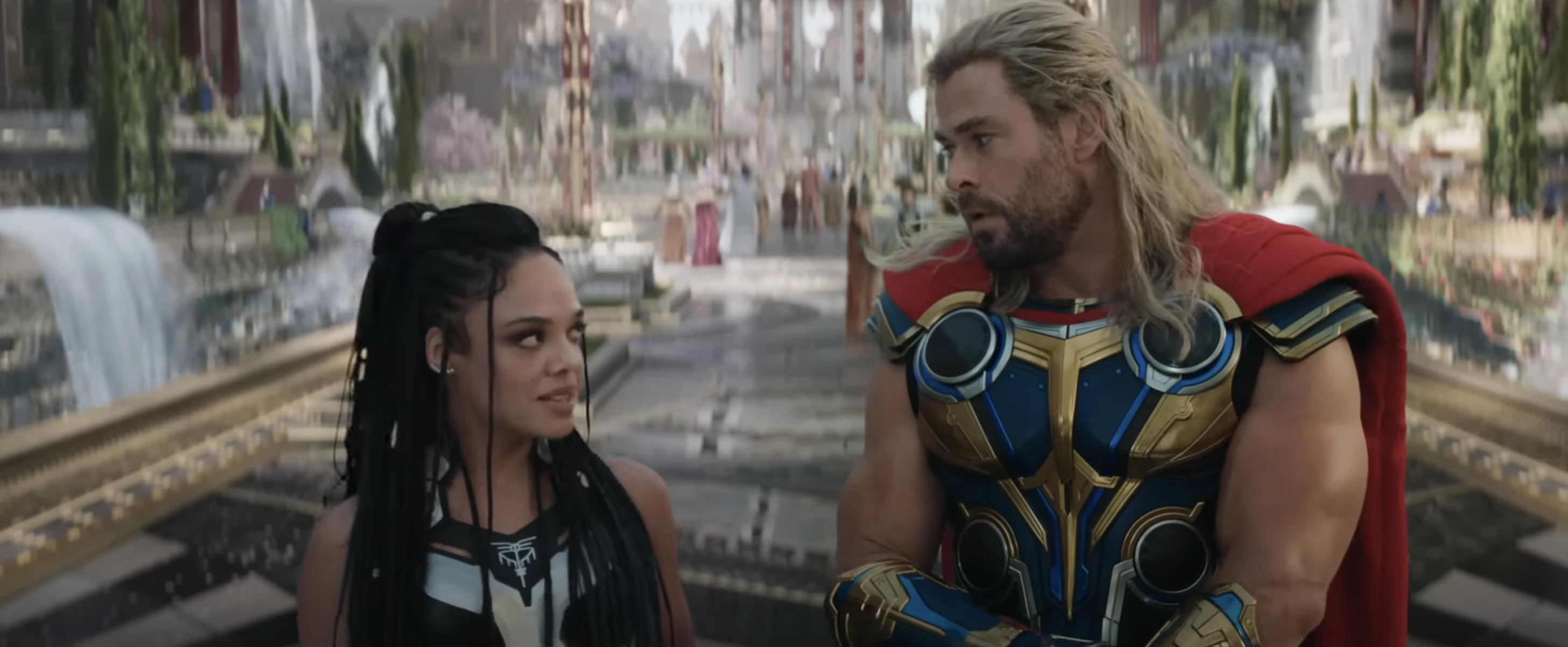 Valkyrie and Thor in armor stand together with a futuristic cityscape in the background