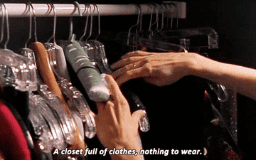 Gif of Carrie from &quot;Sex and the City&#x27; rifling through her closet saying &quot;A closet full of clothes, nothing to wear&quot;