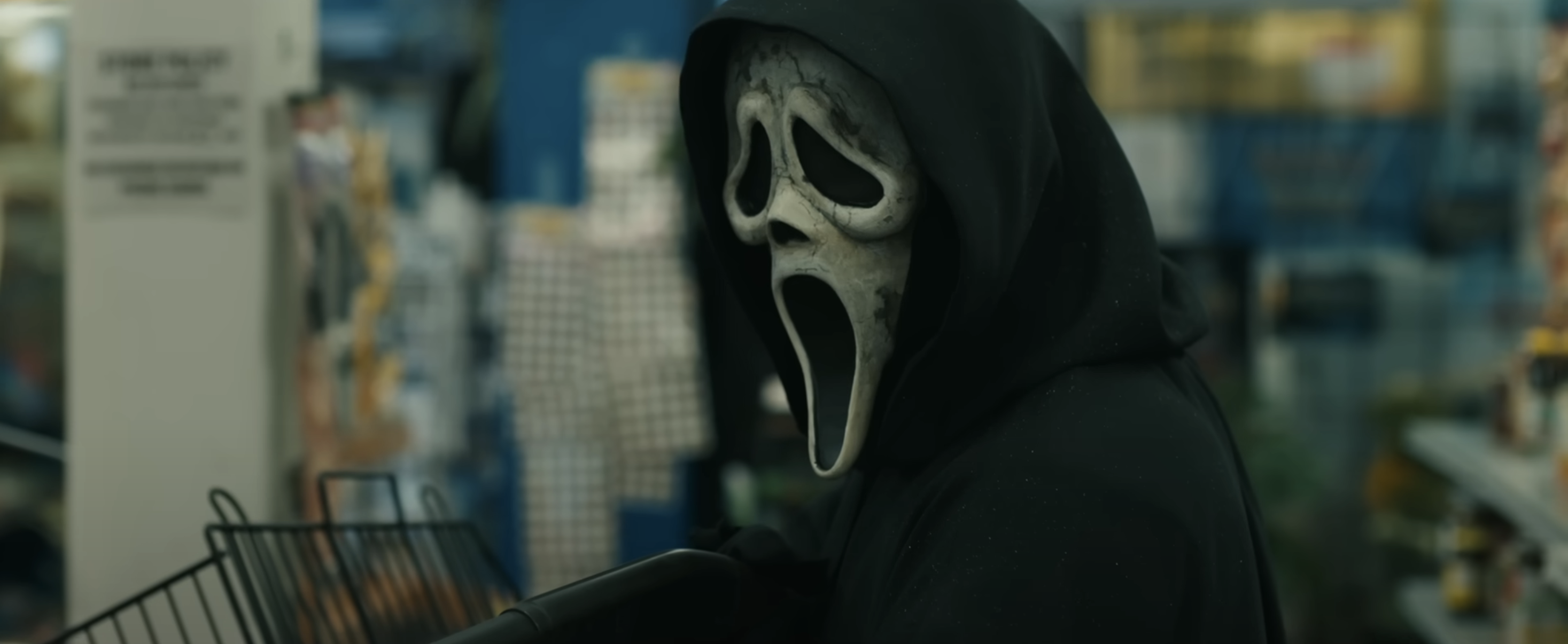 Ghostface standing in a store aisle from the Scream franchise