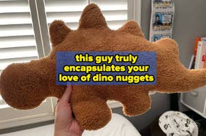 reviewer holding up stegosaurus nugget pillow "this guy truly encapsulates your love of dino nuggets"