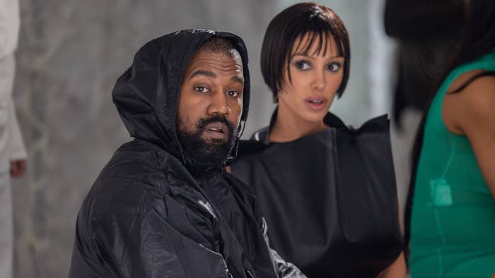 Kanye West and Kim Kardashian wearing modern outfits at an event