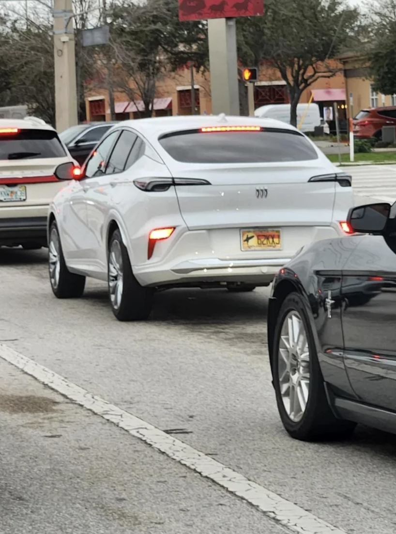 A car with lights very low on the bumper