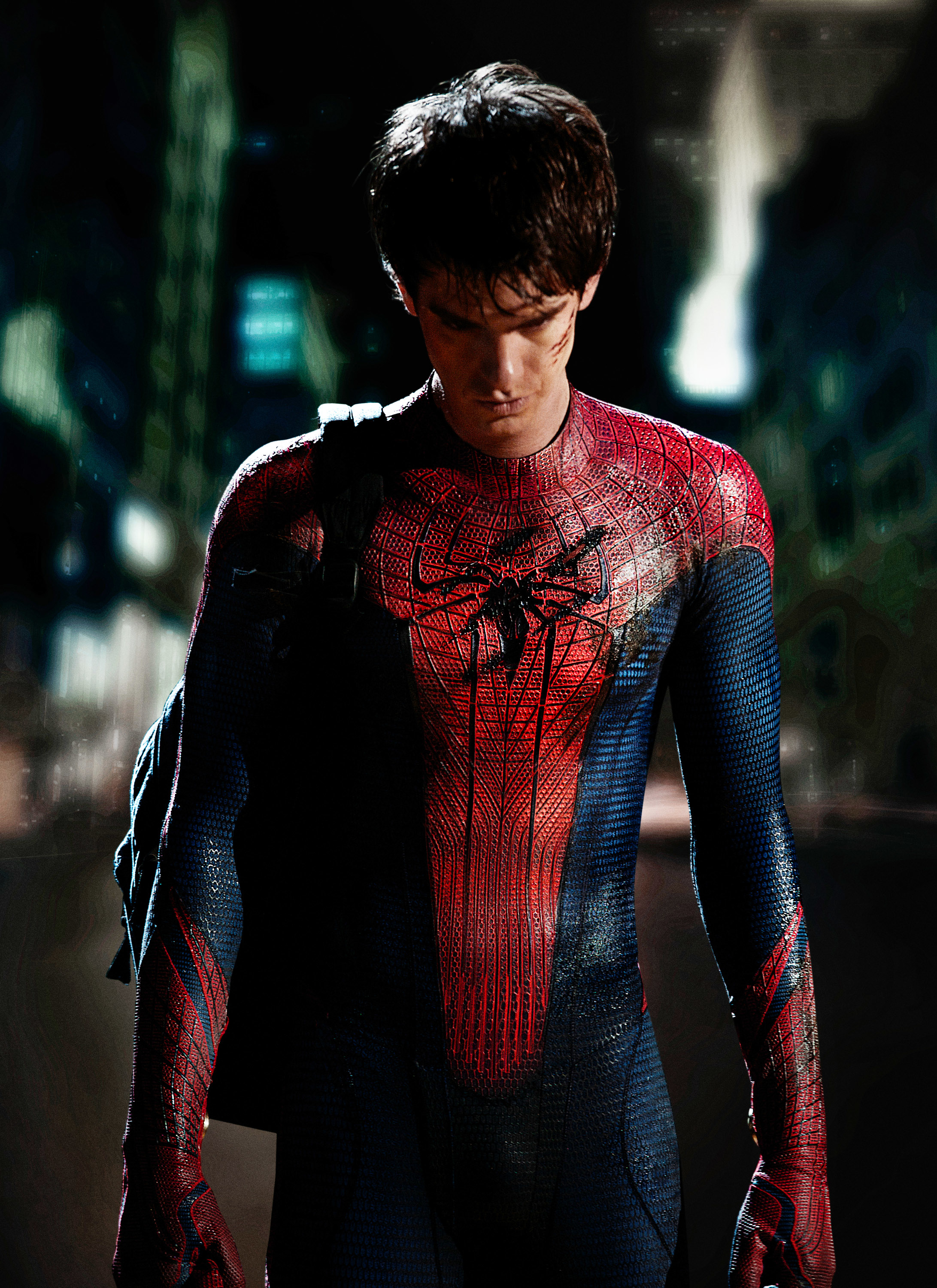 Andrew Garfield in a Spider-Man costume with a cityscape in the background