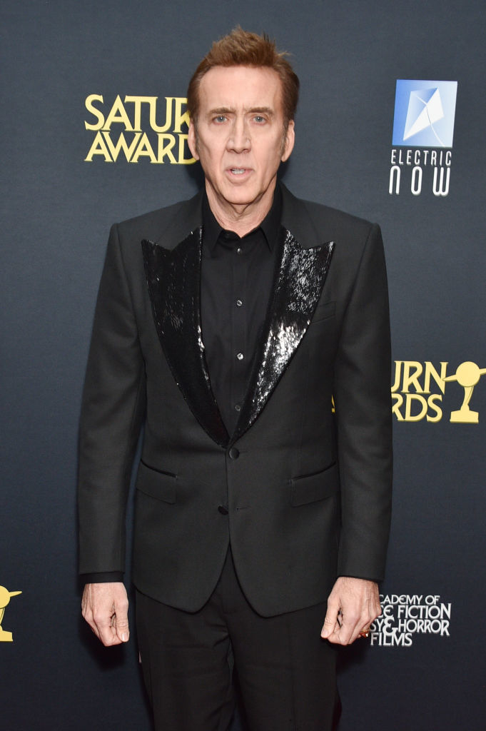 Nicolas Cage poses in a suit with a sparkling lapel at the Saturn Awards