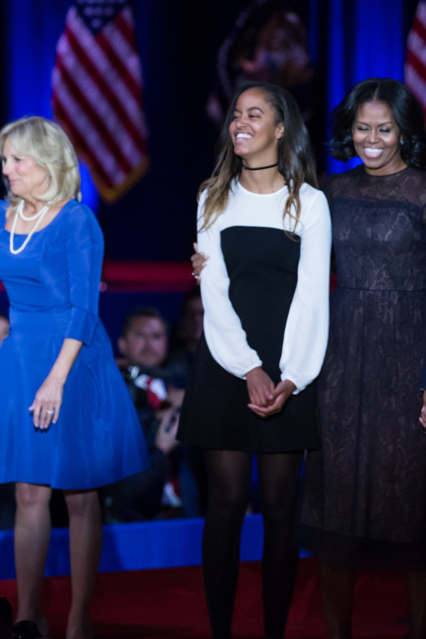 Malia Obama, Michelle Obama, and Barack Obama at an event, smiling