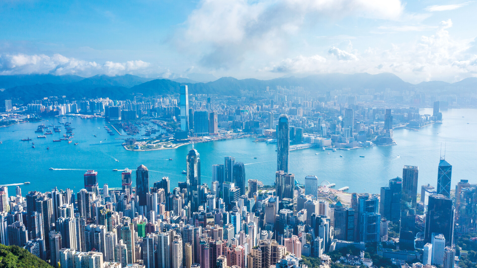 Aerial view of Hong Kong&#x27;s dense skyline and Victoria Harbour on a clear day