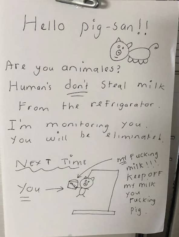 Handwritten note with drawings warning against stealing milk from the fridge, humorously addressed to a "pig-san."