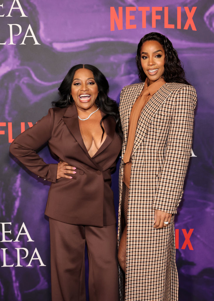 Sherri and Kelly in stylish suits posing together at a Netflix event