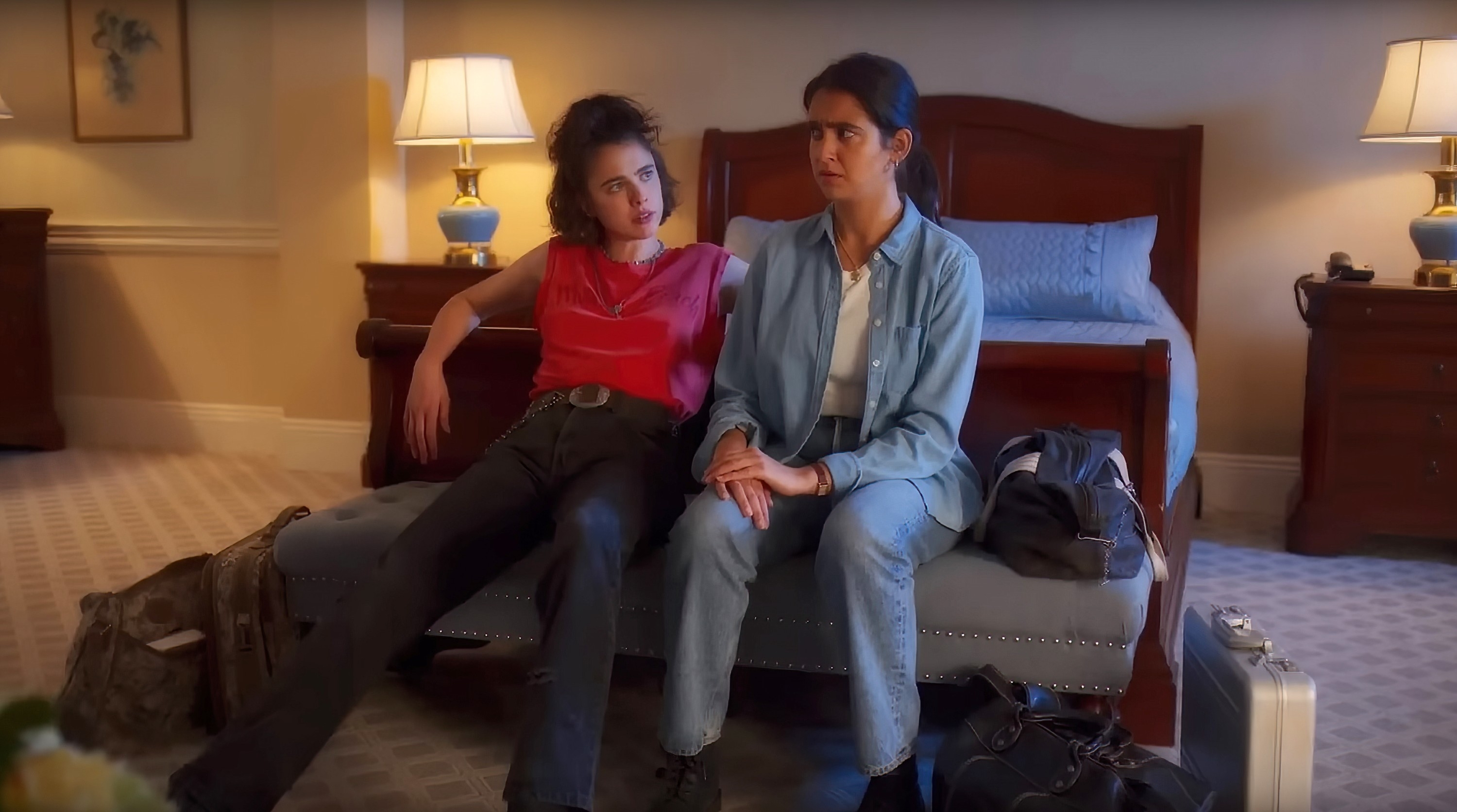 Jamie and Marian sitting in front of a bed in a scene from &quot;Drive-Away Dolls&quot;