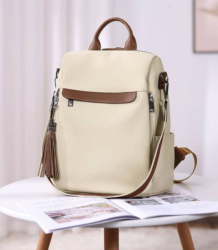 the backpack in beige sitting on a table