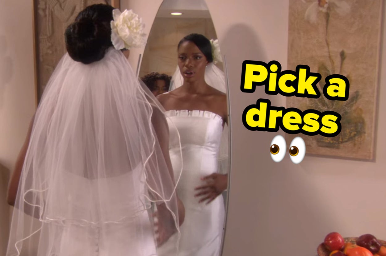 A woman looking in the mirror at her wedding dress.