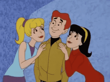 Animated characters Archie, Betty, and Veronica from "Archie Comics" are depicted with Betty and Veronica kissing Archie on his cheeks