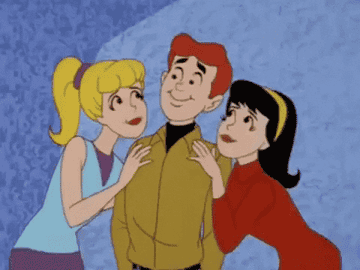 Animated characters Archie, Betty, and Veronica from &quot;Archie Comics&quot; are depicted with Betty and Veronica kissing Archie on his cheeks