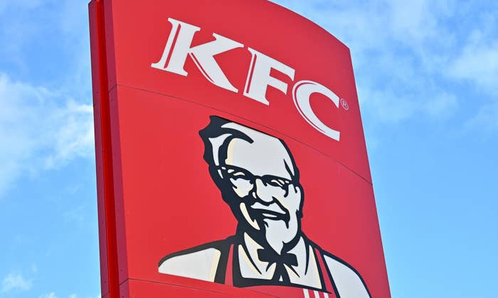 KFC logo with Colonel Sanders&#x27; illustration on a sign against the sky