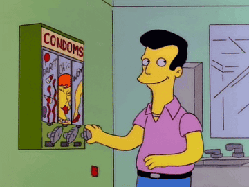 Animated character selecting a product from a vending machine labeled &quot;condoms&quot; in a humorous context