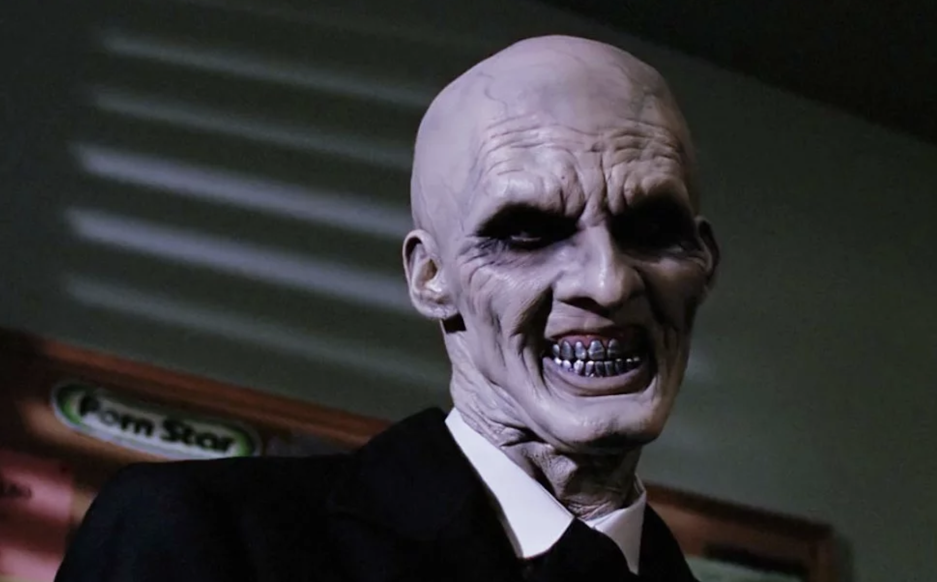 The character The Gentlemen from the TV show Buffy the Vampire Slayer, featuring a bald, sinister appearance with a wide, toothy smile