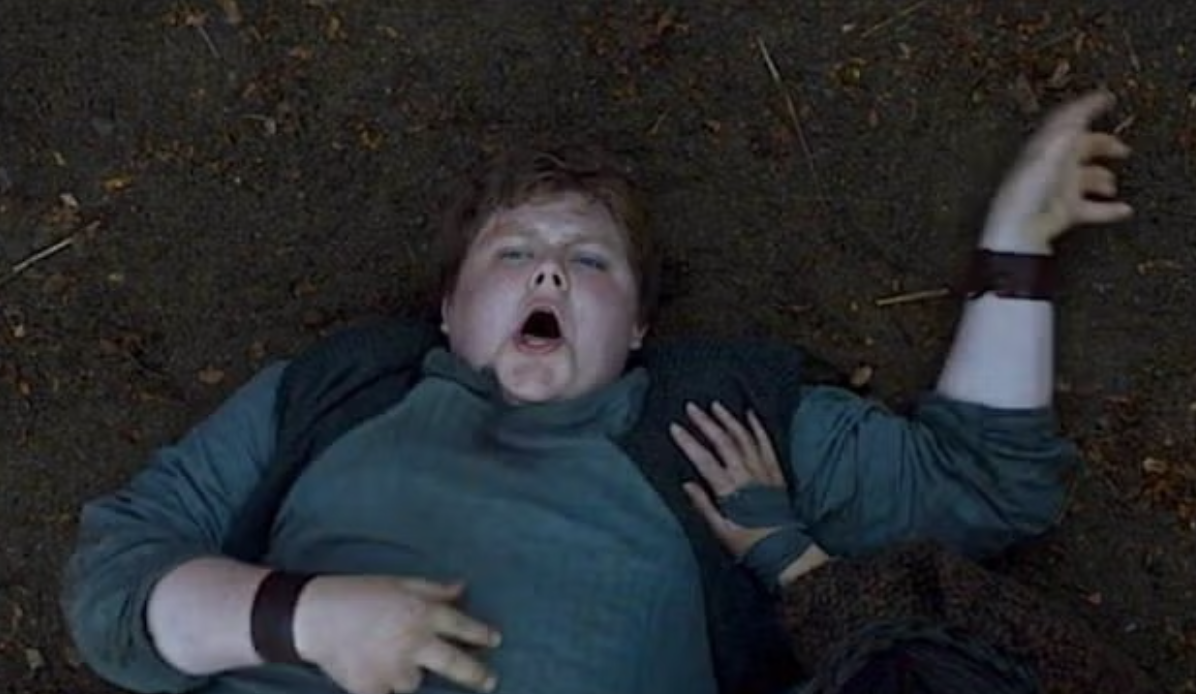 Character from a show or film lying on the ground with a shocked expression