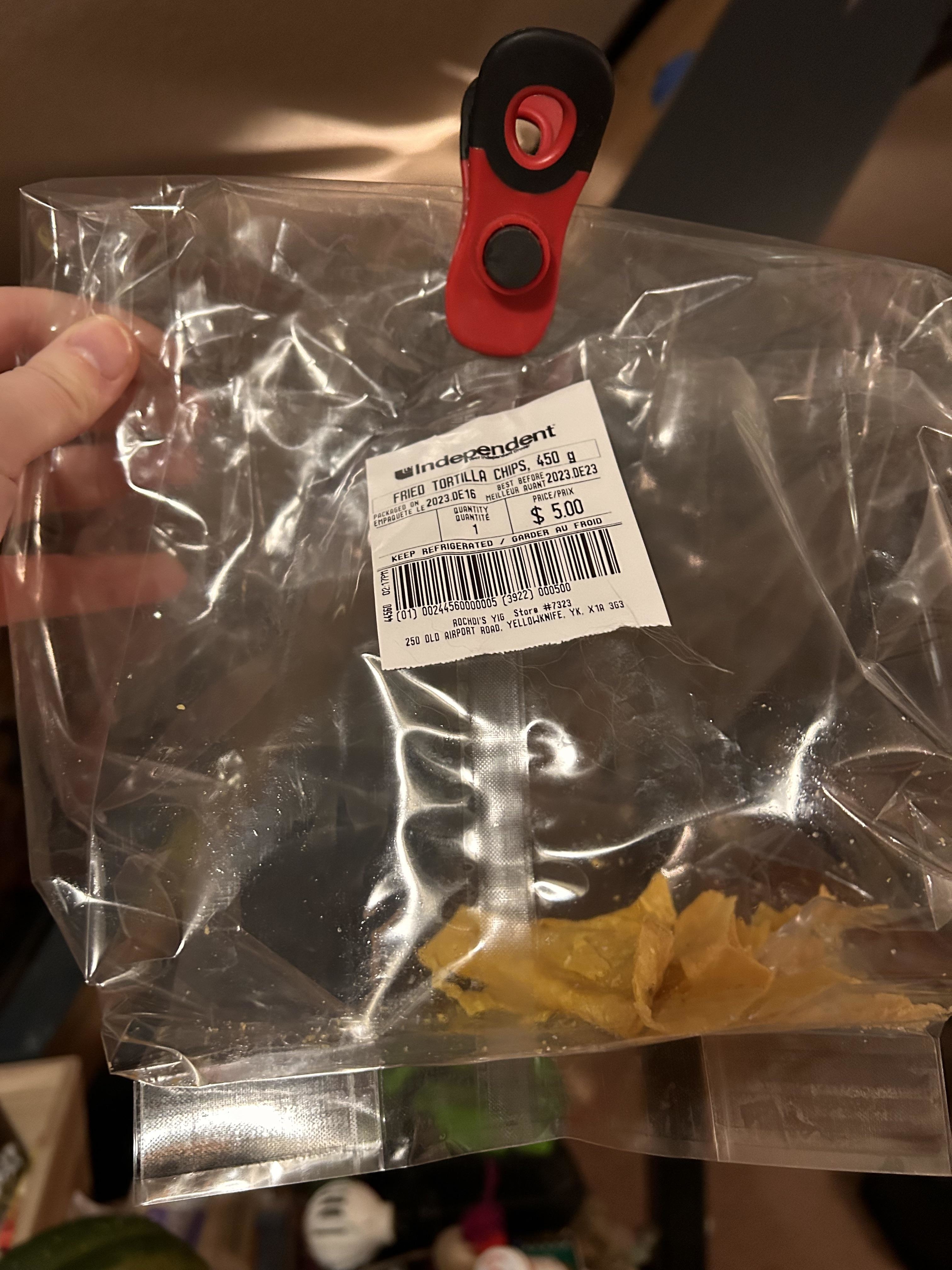 Clear plastic packaging with a red toggle closure and a price tag attached