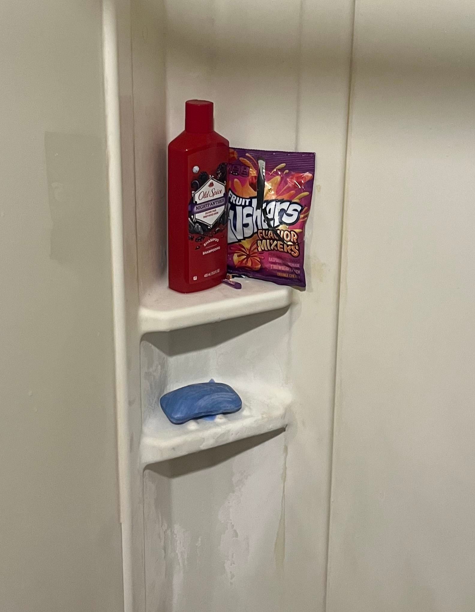 Shower caddy with various personal care products and a packet of candy