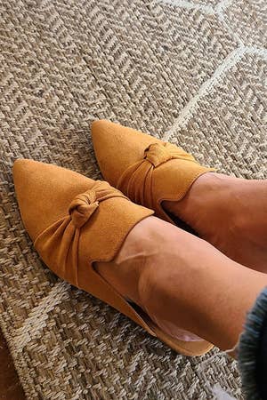 Reviewer wearing the tan knot mules
