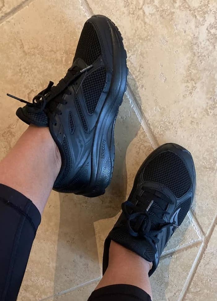 Reviewer wearing the black sneakers