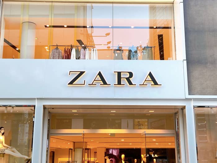 Storefront of ZARA with display windows showcasing clothing